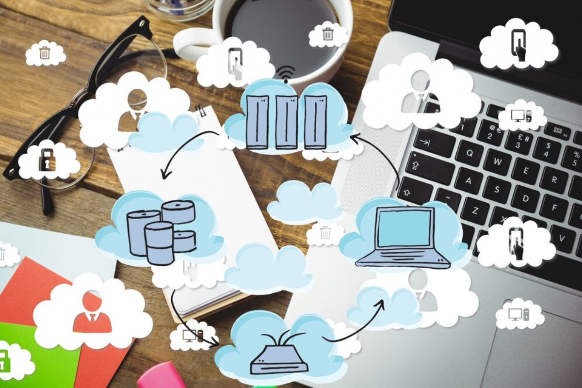 A laptop and coffee cup surrounded by cloud icons representing data storage, security, and user interactions on a wooden desk.