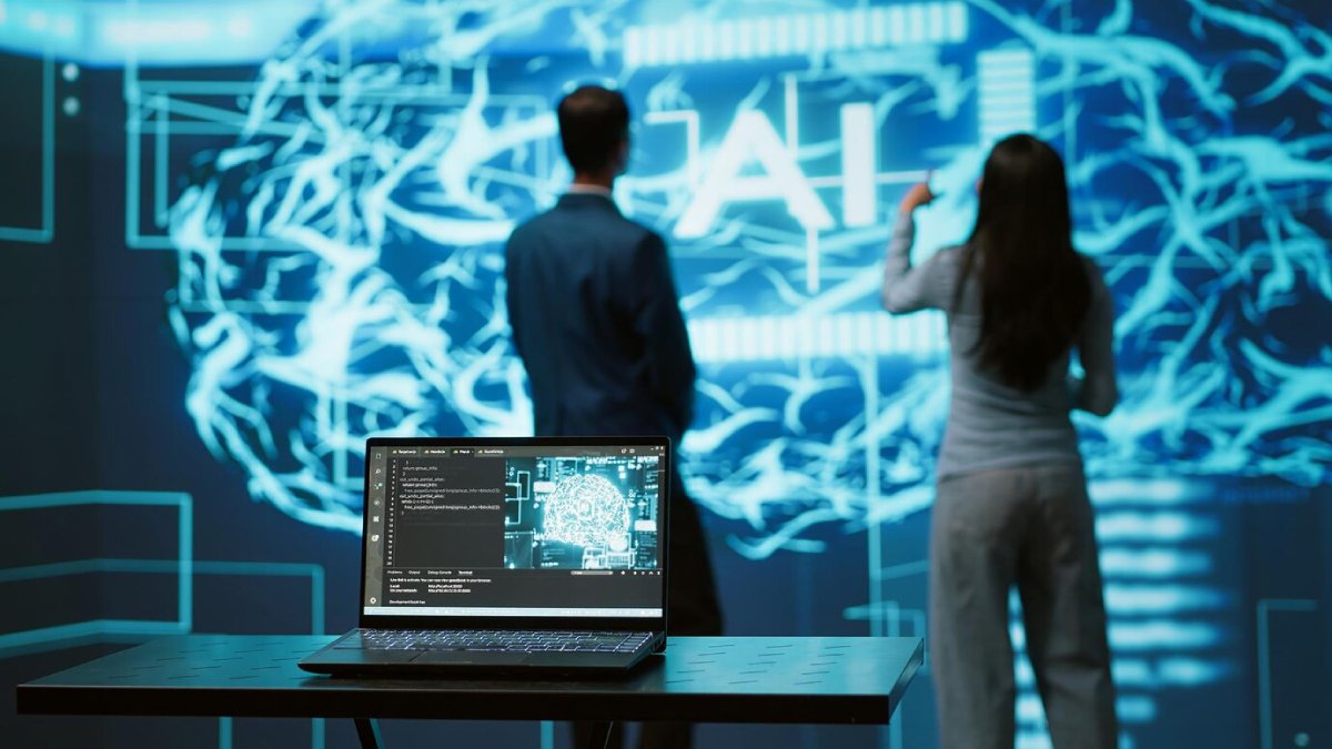 Two professionals analyze a digital brain interface displaying 