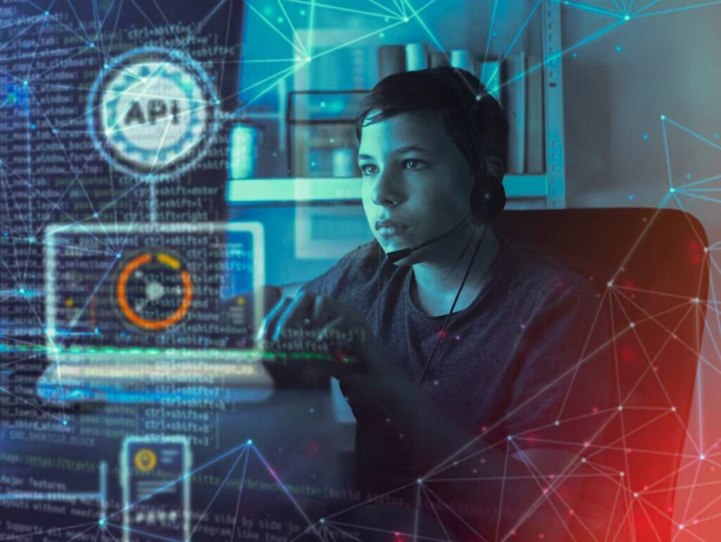 A person working on a laptop in a dark room, surrounded by digital code and network lines, indicating a tech or programming environment.